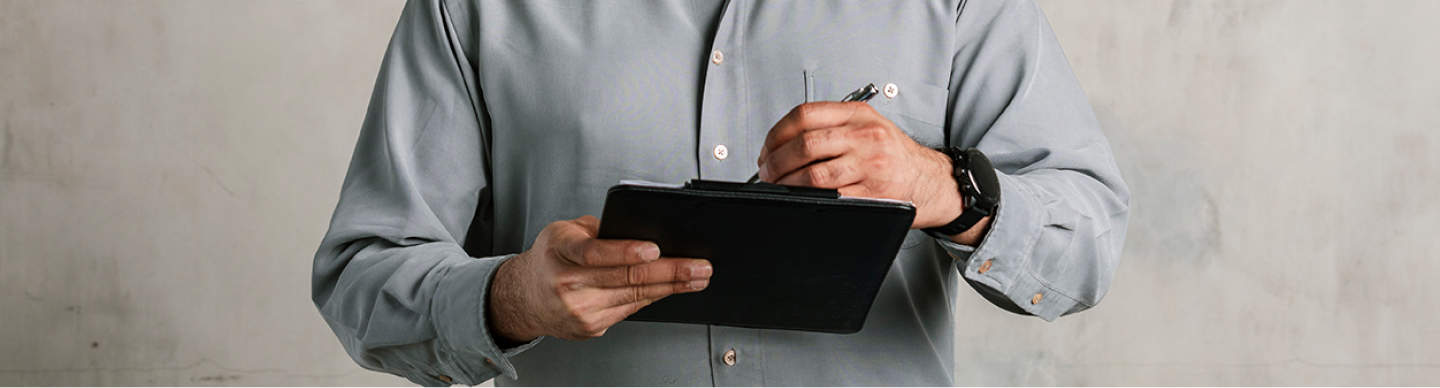 a person holding a pen signing a document