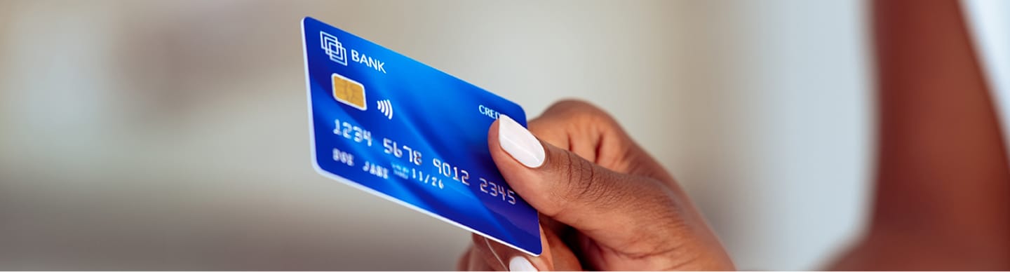 a hand holding a credit card