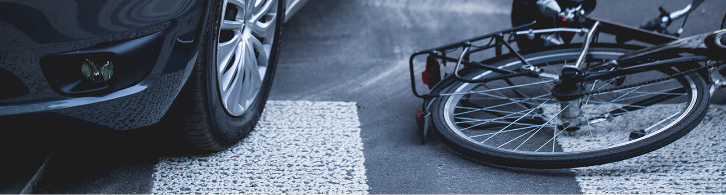 A bicycle and a car are on the road.